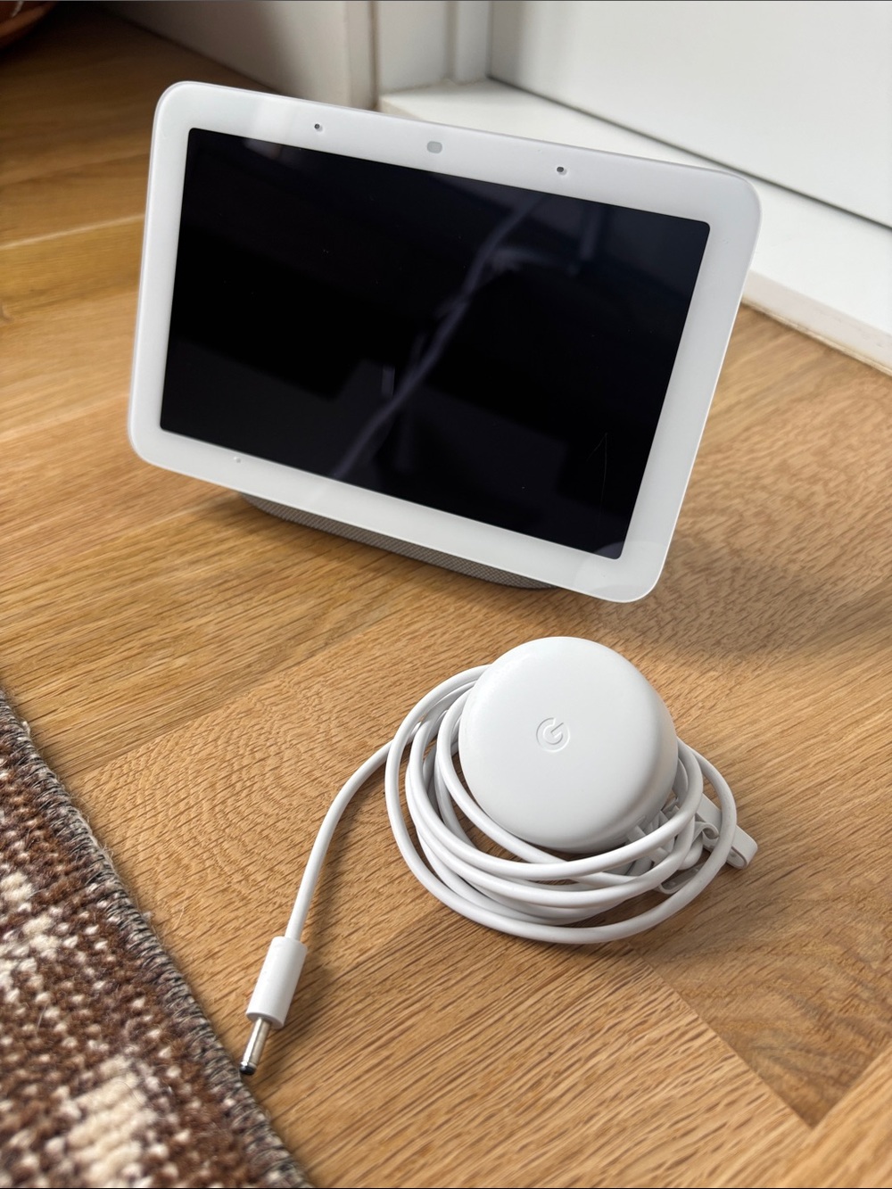 google Nest Hub smart display with white charger